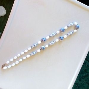 Women's white and dark blue necklace.